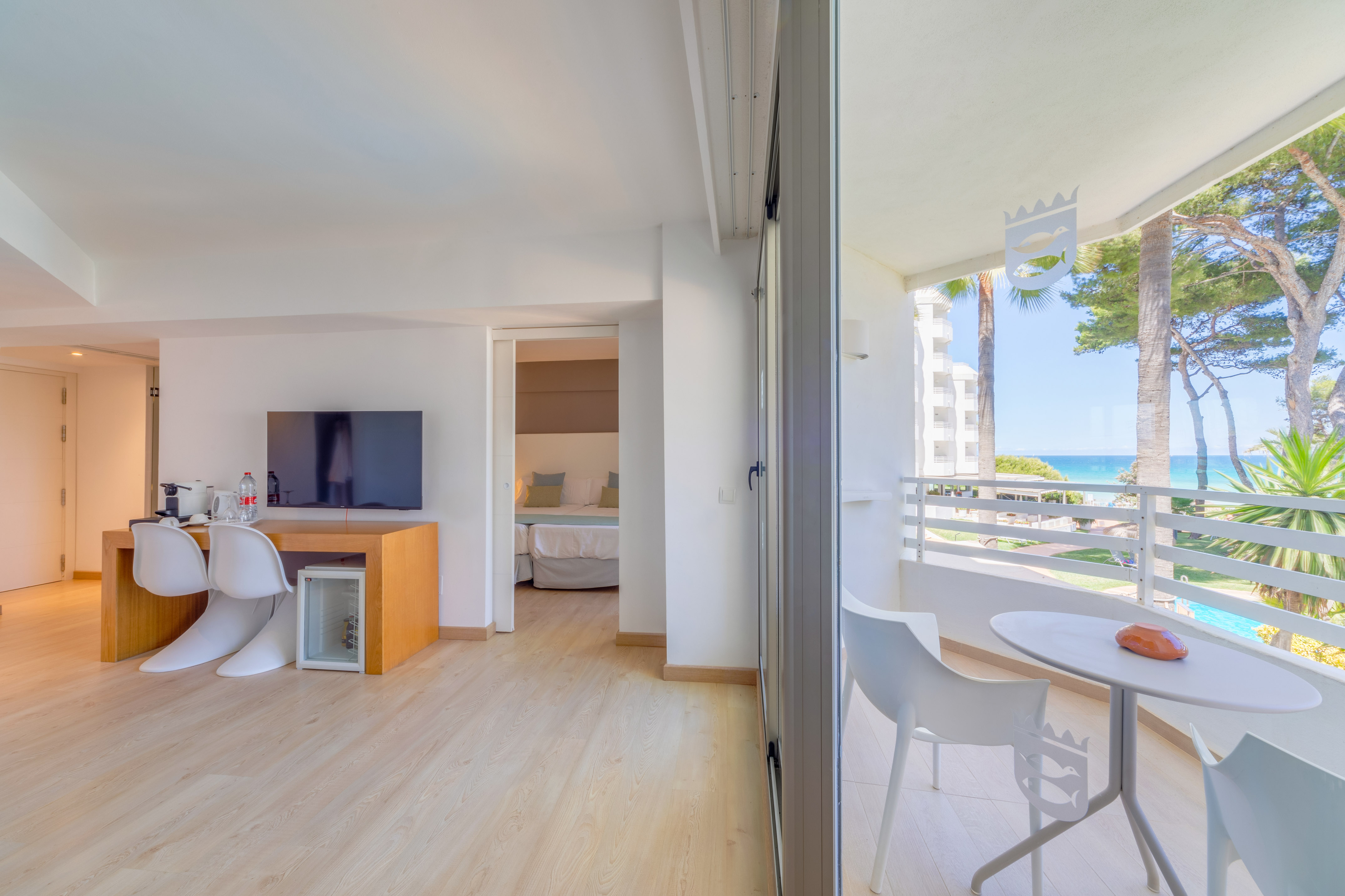 a room with a table and chairs and a television