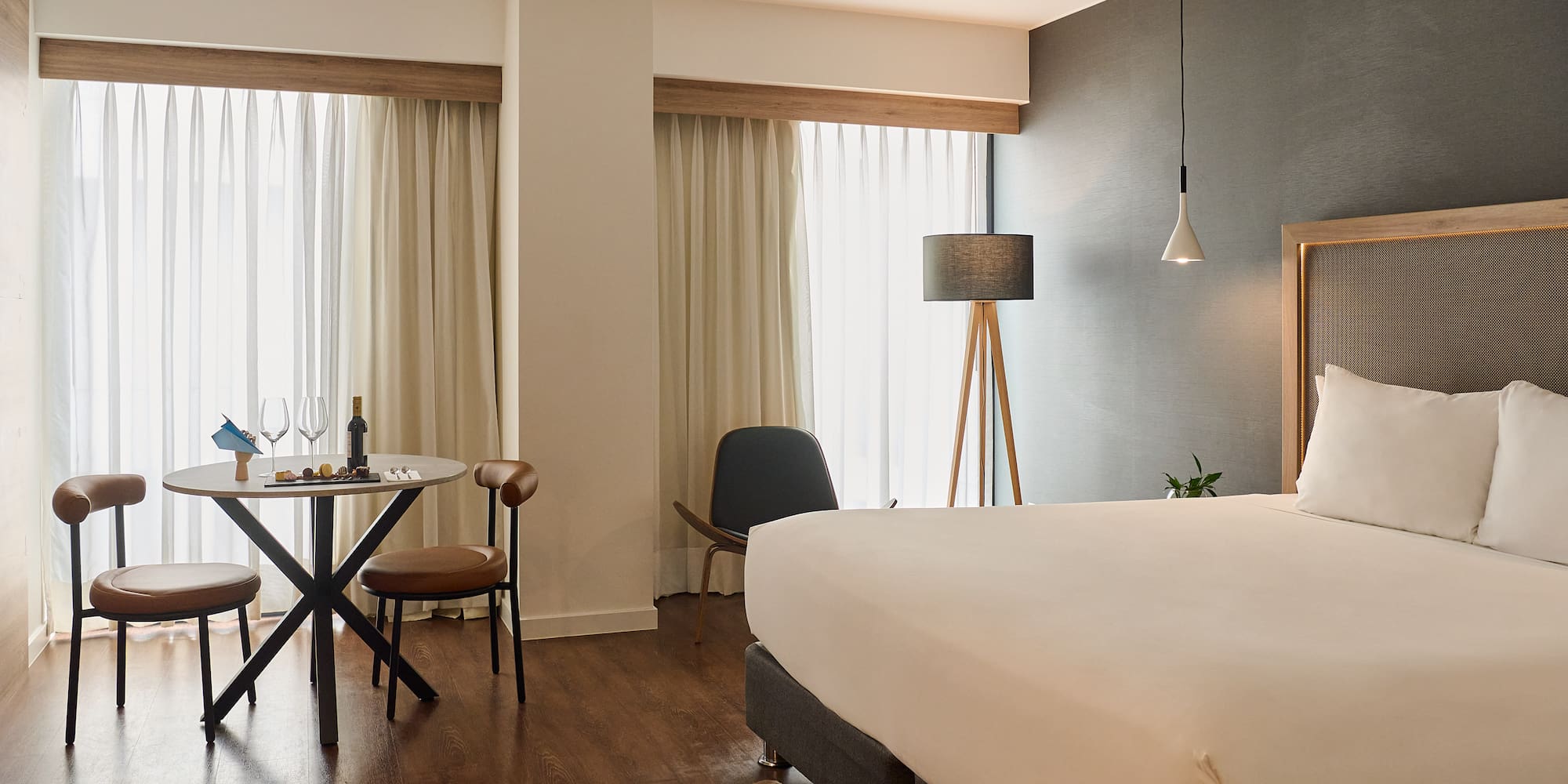 a room with a bed and a table and chairs