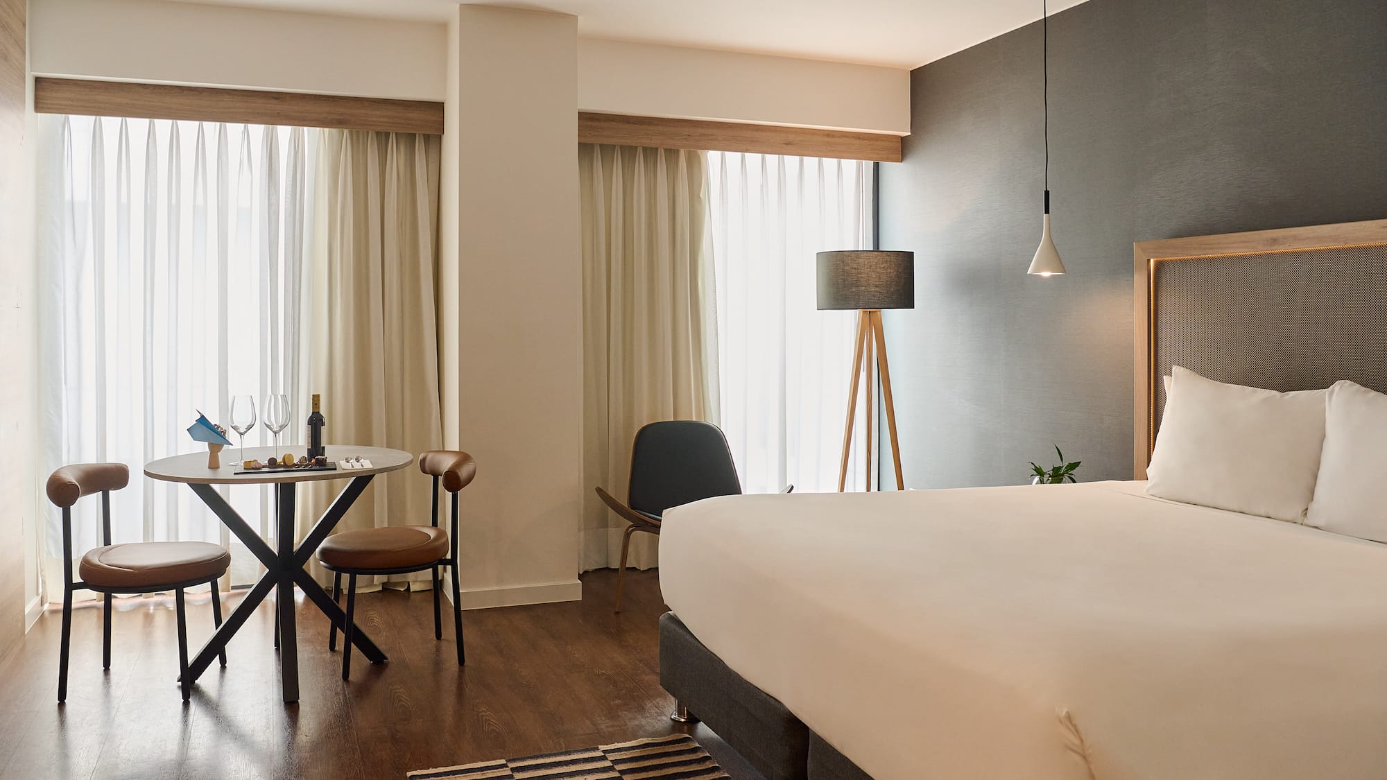 a room with a bed and a table and chairs