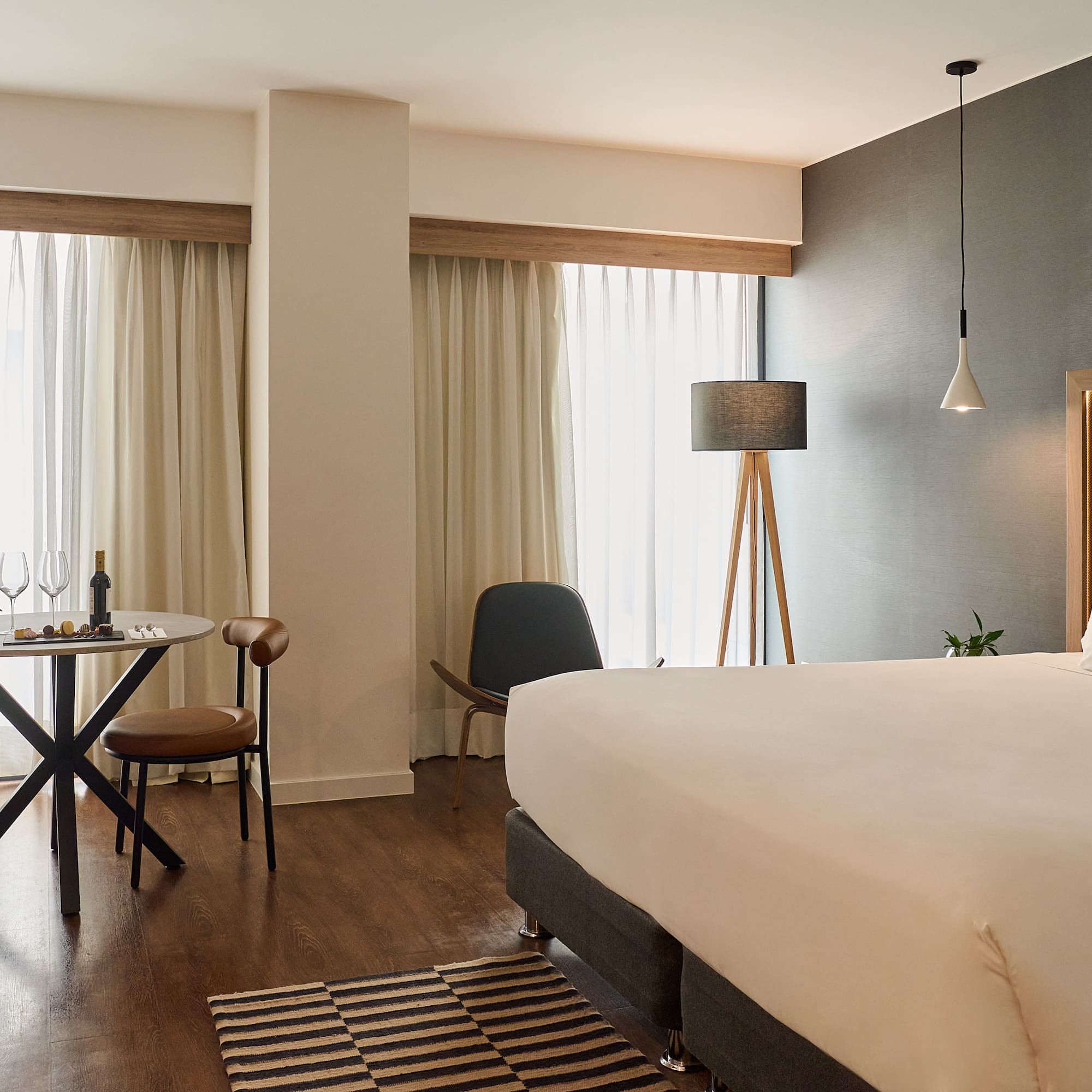 a room with a bed and a table and chairs