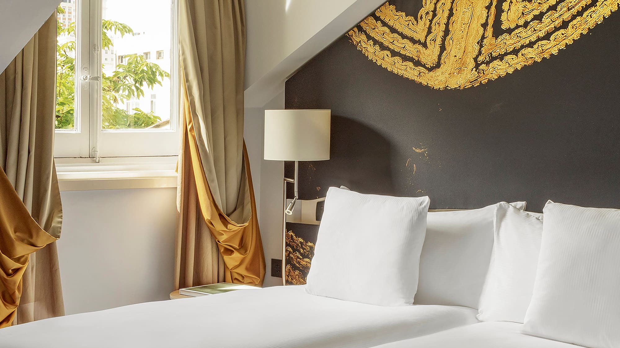 a room with two beds and a window