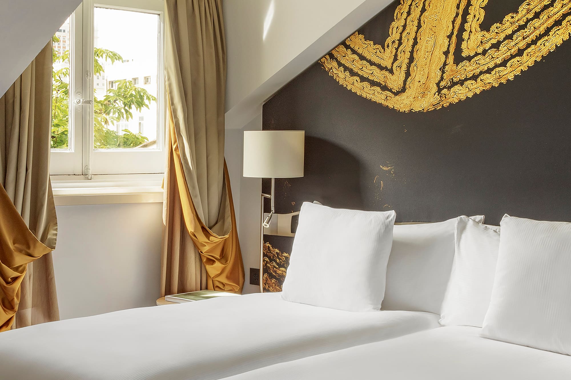 a room with two beds and a window