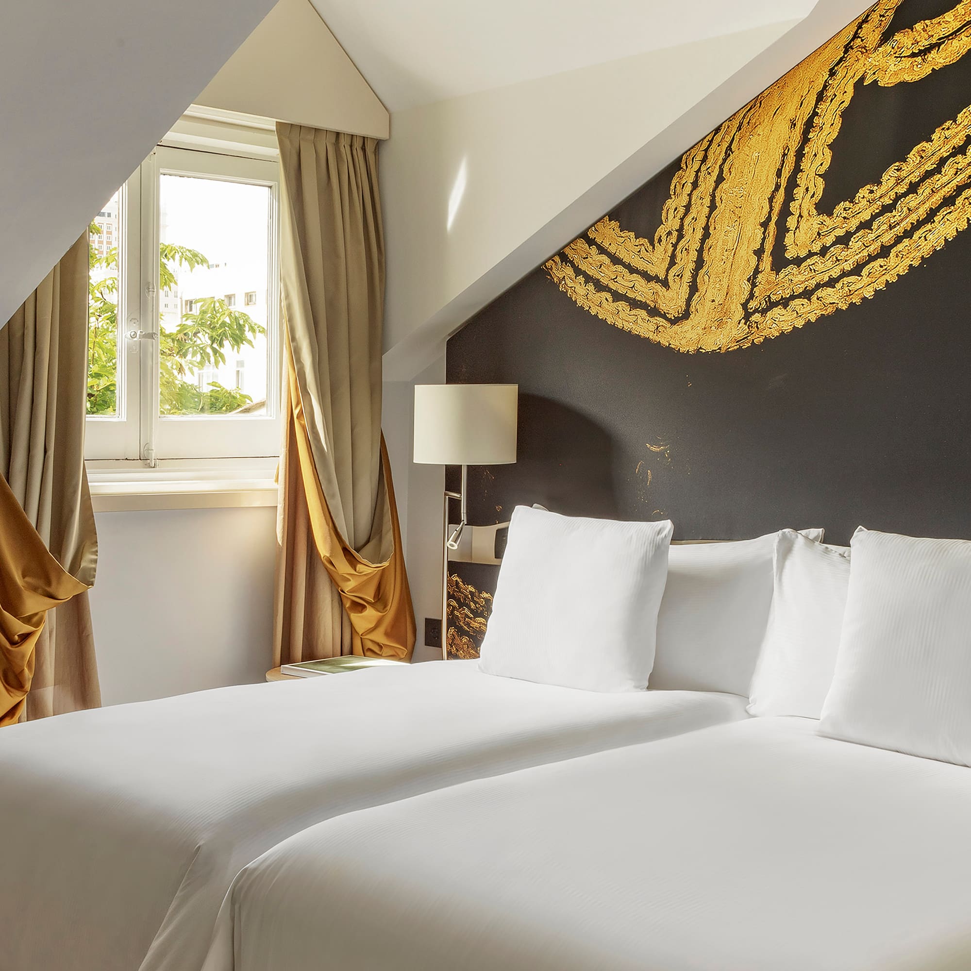 a room with two beds and a window