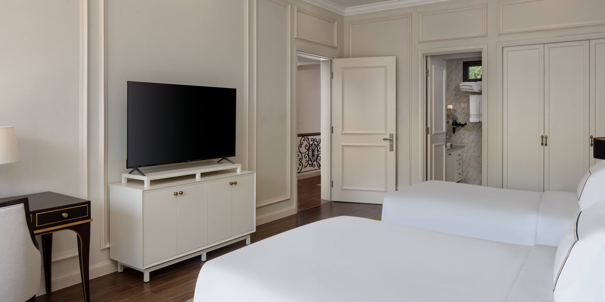 a room with two beds and a tv