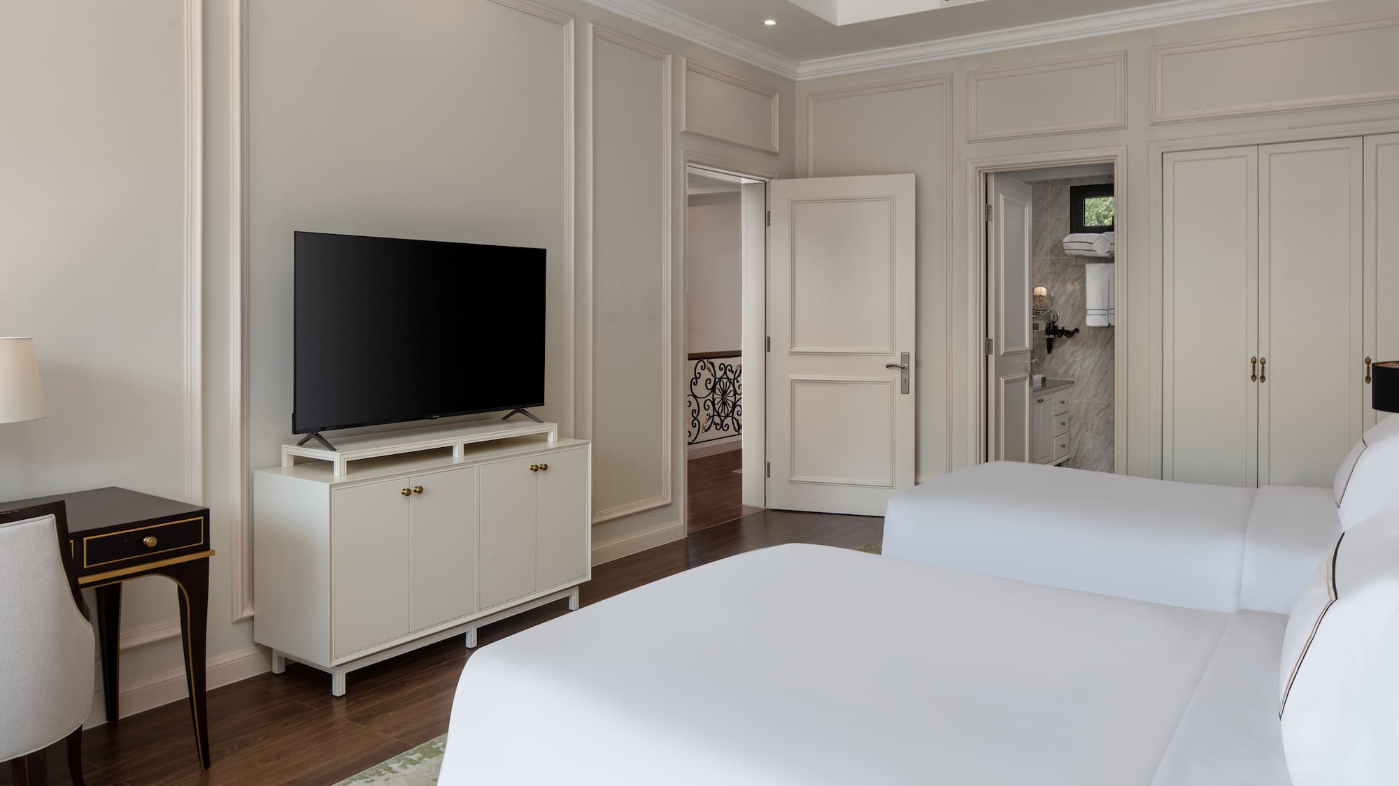 a room with two beds and a tv