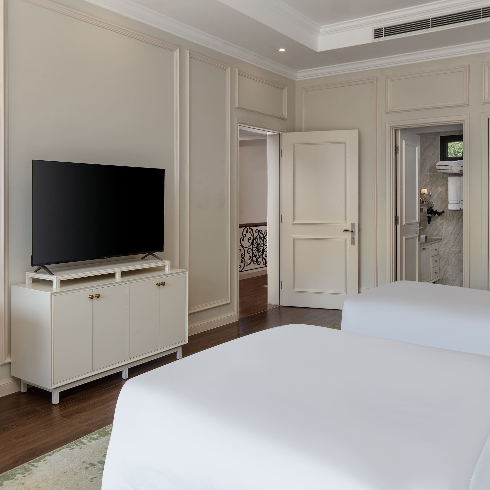 a room with two beds and a tv