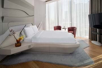 a bed in a room with a chair and a table