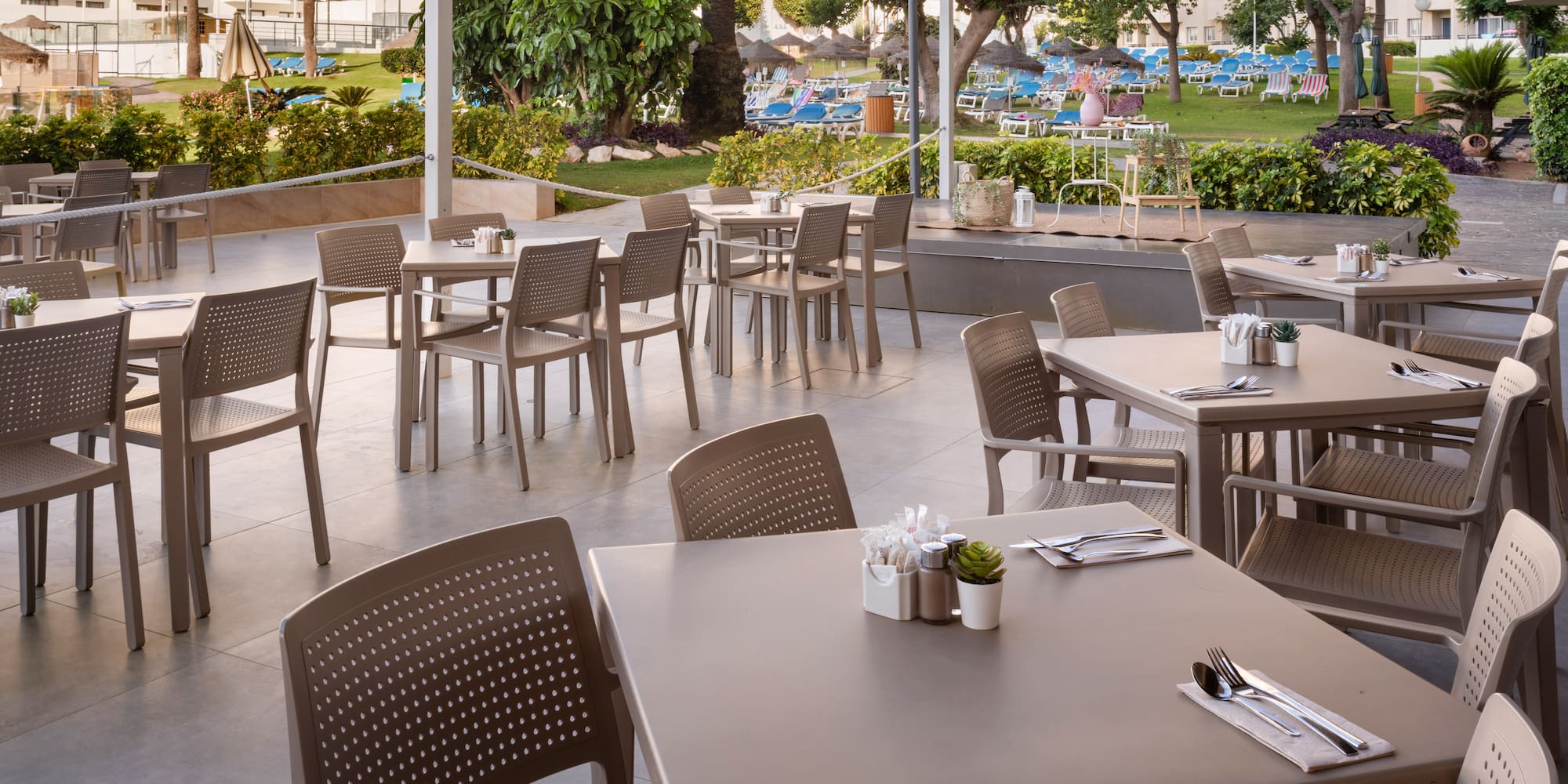 a patio with tables and chairs