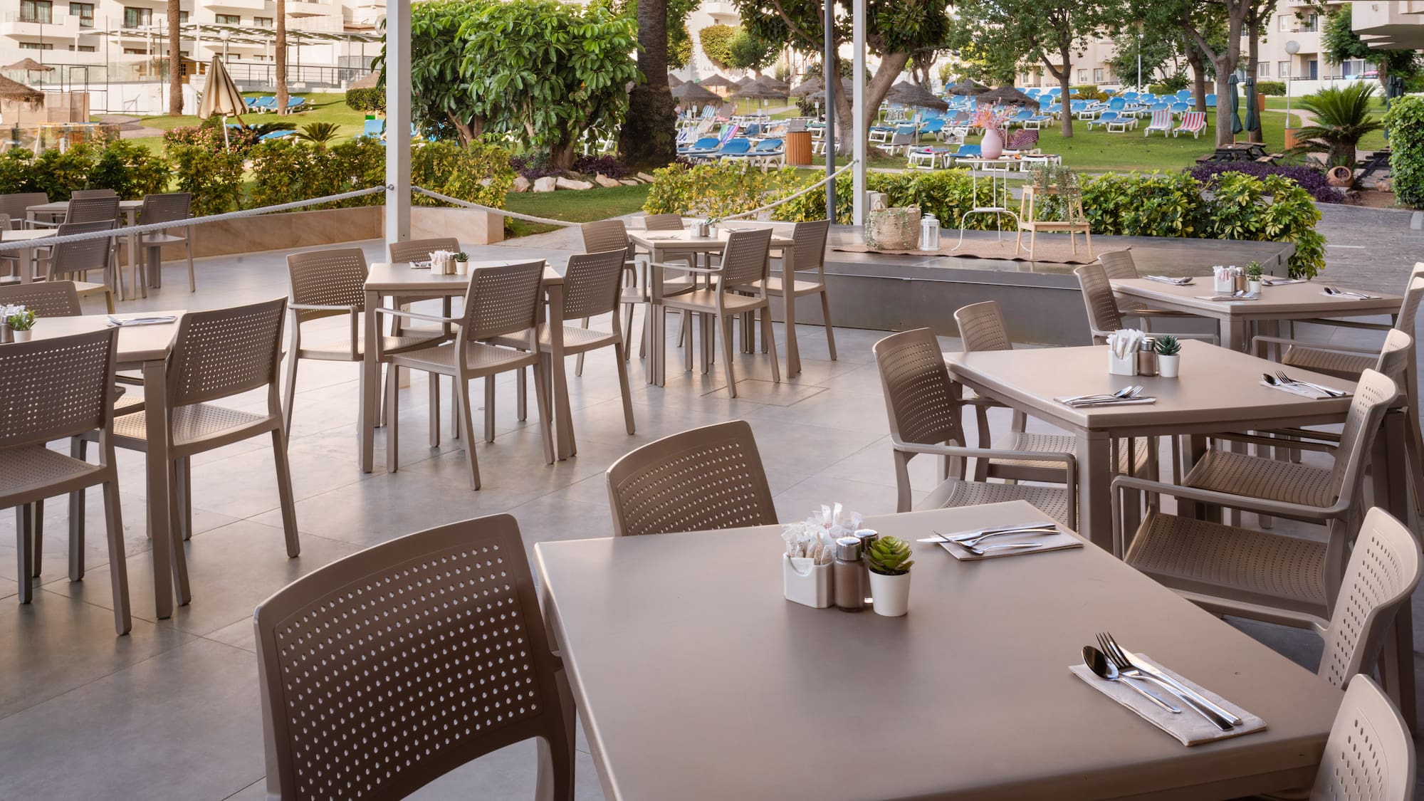 a patio with tables and chairs