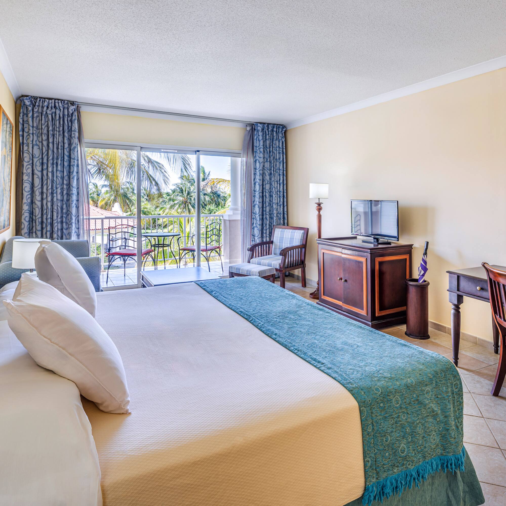 a room with a bed and a television