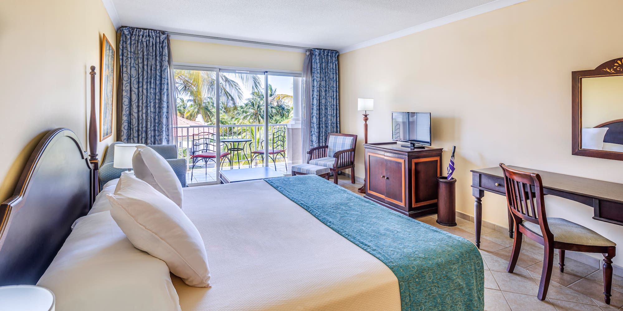 a room with a bed and a television