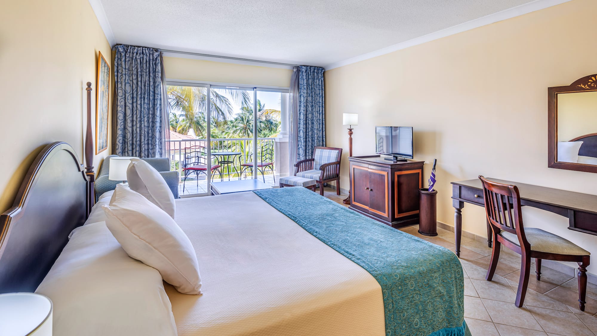 a room with a bed and a television