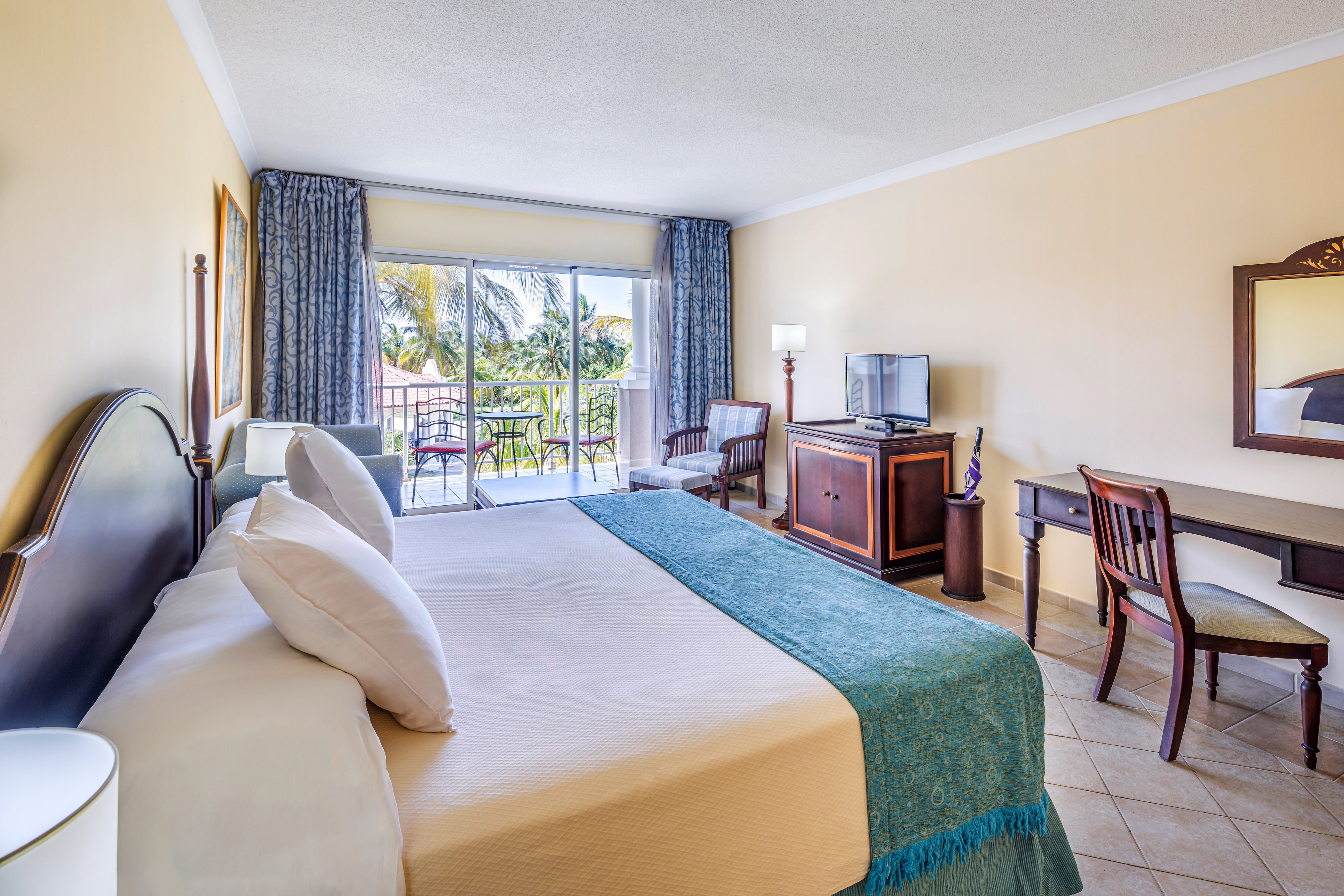 a room with a bed and a television