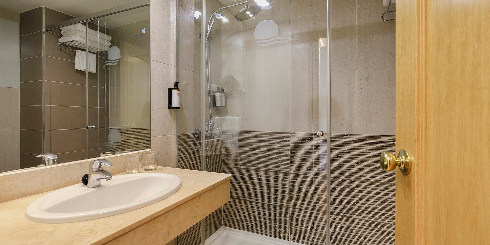 a bathroom with a glass shower and sink