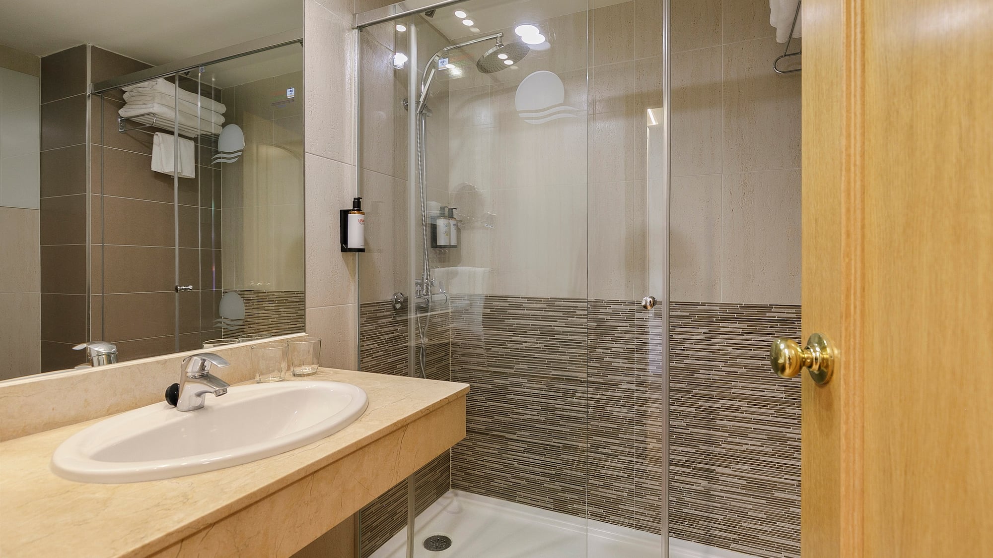 a bathroom with a glass shower and sink