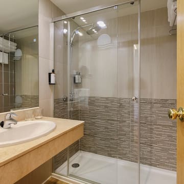 a bathroom with a glass shower and sink