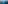 Sailboat in clear blue bay, coastal town, beach, and pine trees.