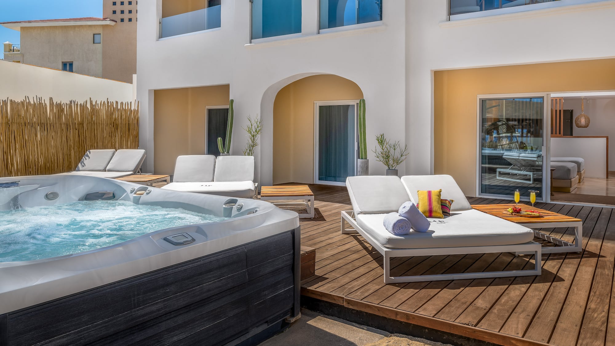a hot tub and lounge chairs on a deck