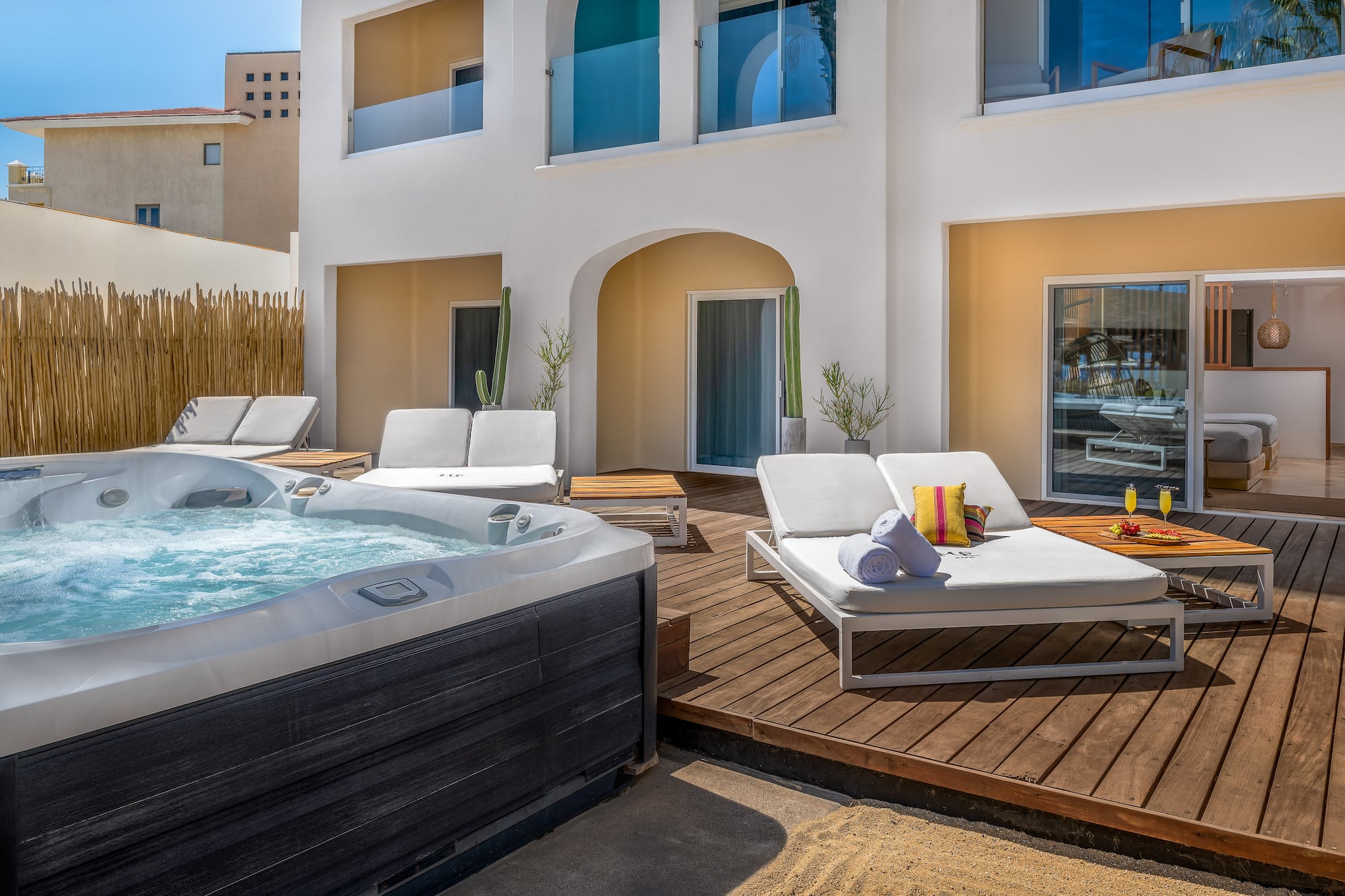 a hot tub and lounge chairs on a deck