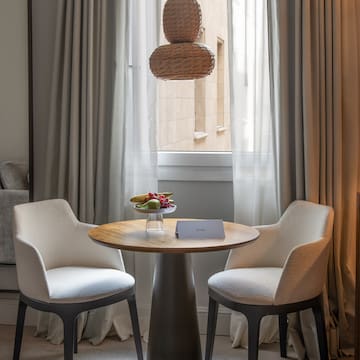 a table with two chairs in front of a window