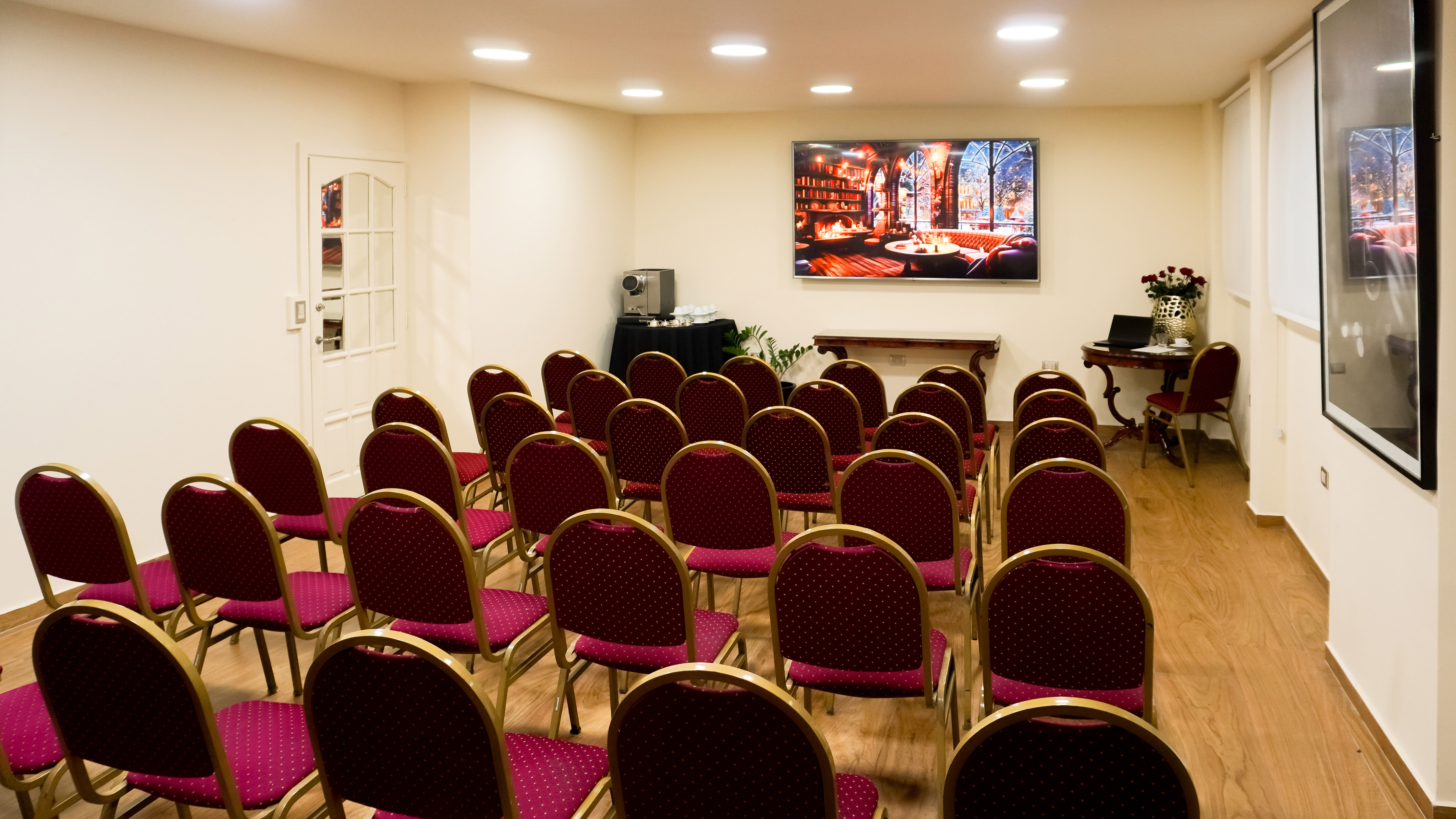 a room with red chairs and a screen
