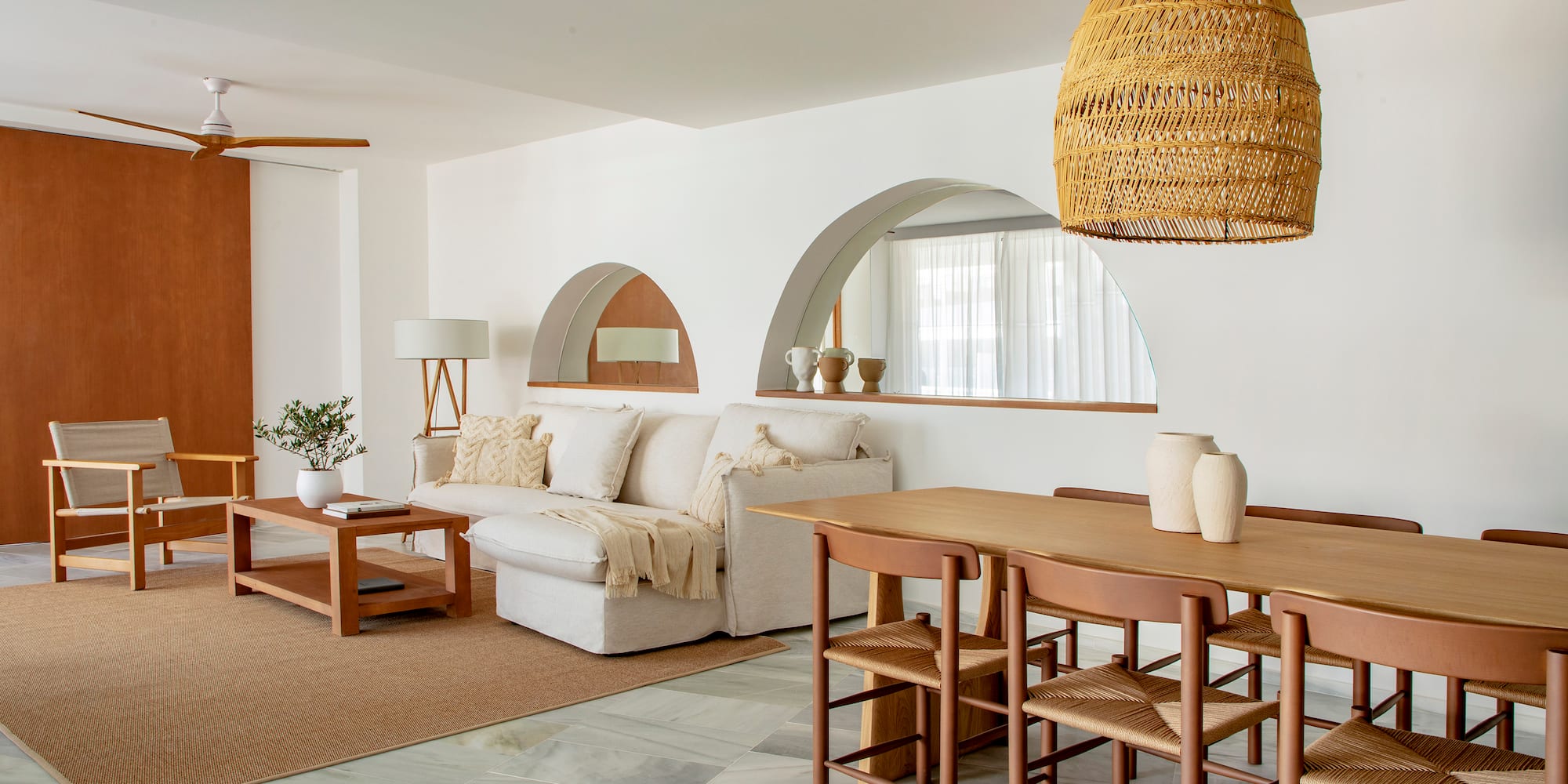 a living room with a table and chairs