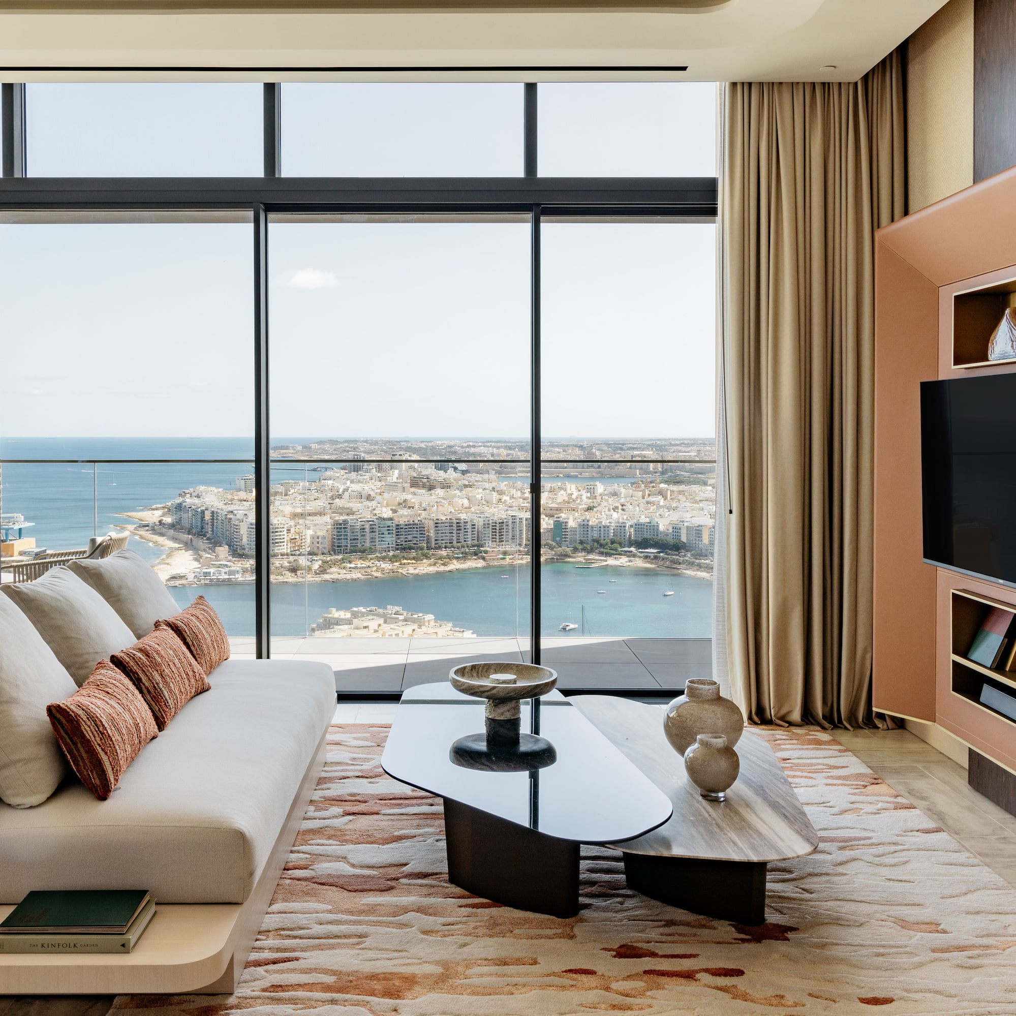 a living room with a large window overlooking a city