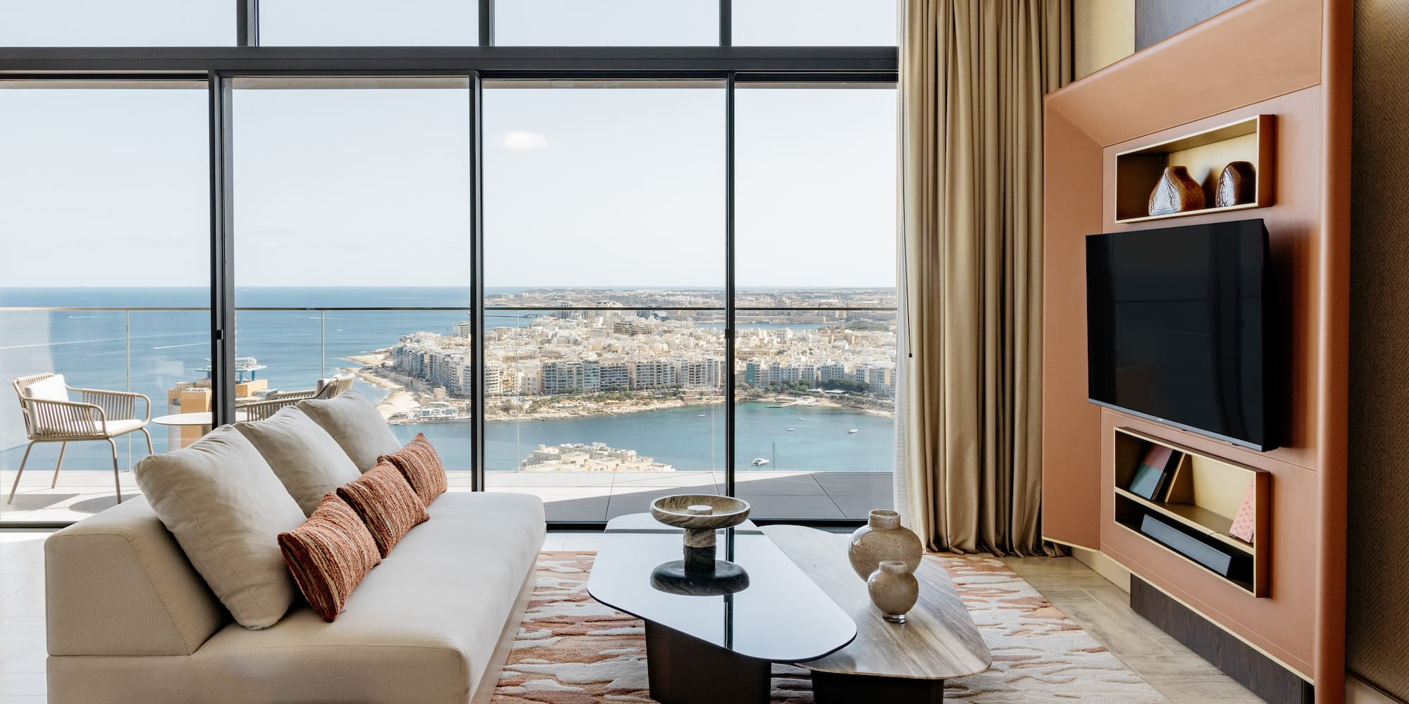 a living room with a large window overlooking a city