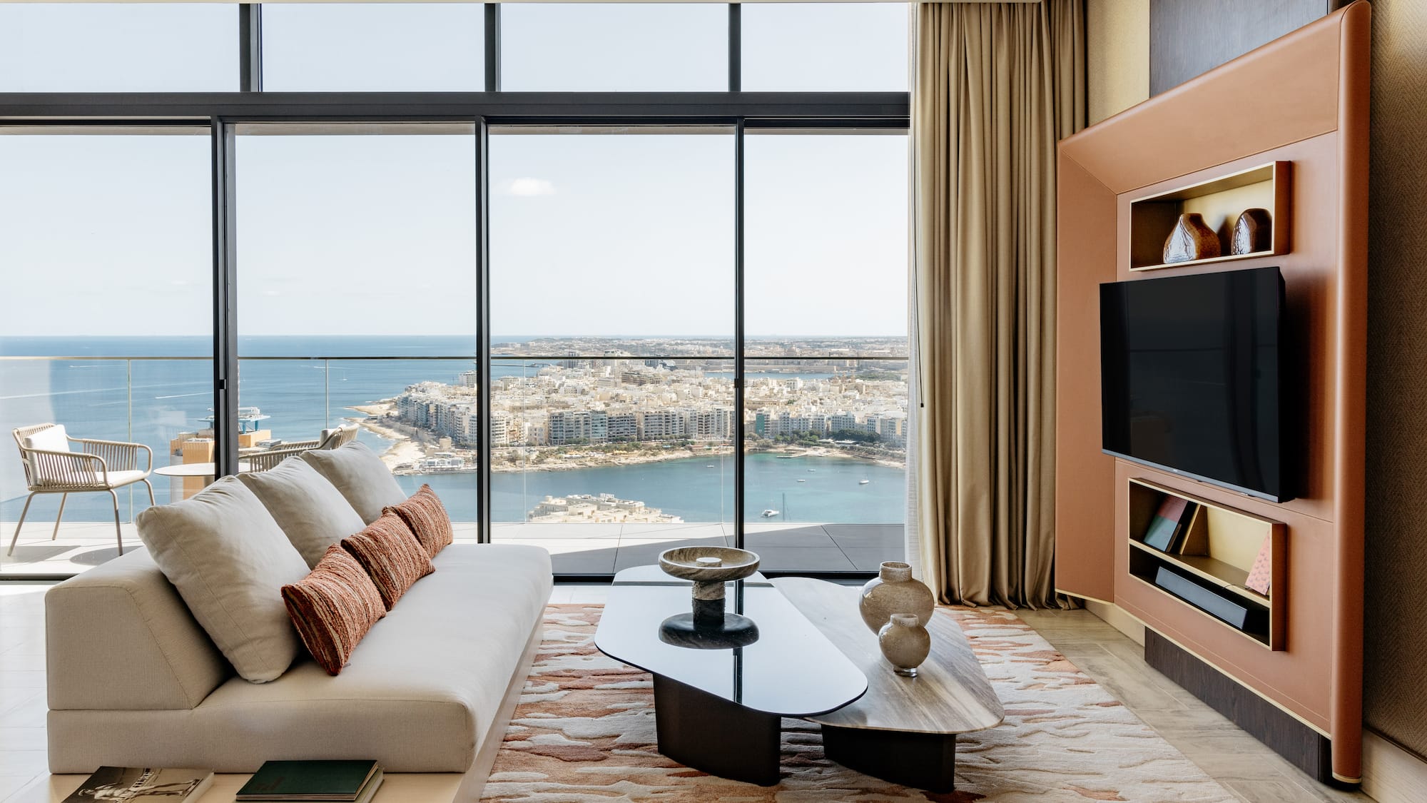 a living room with a large window overlooking a city