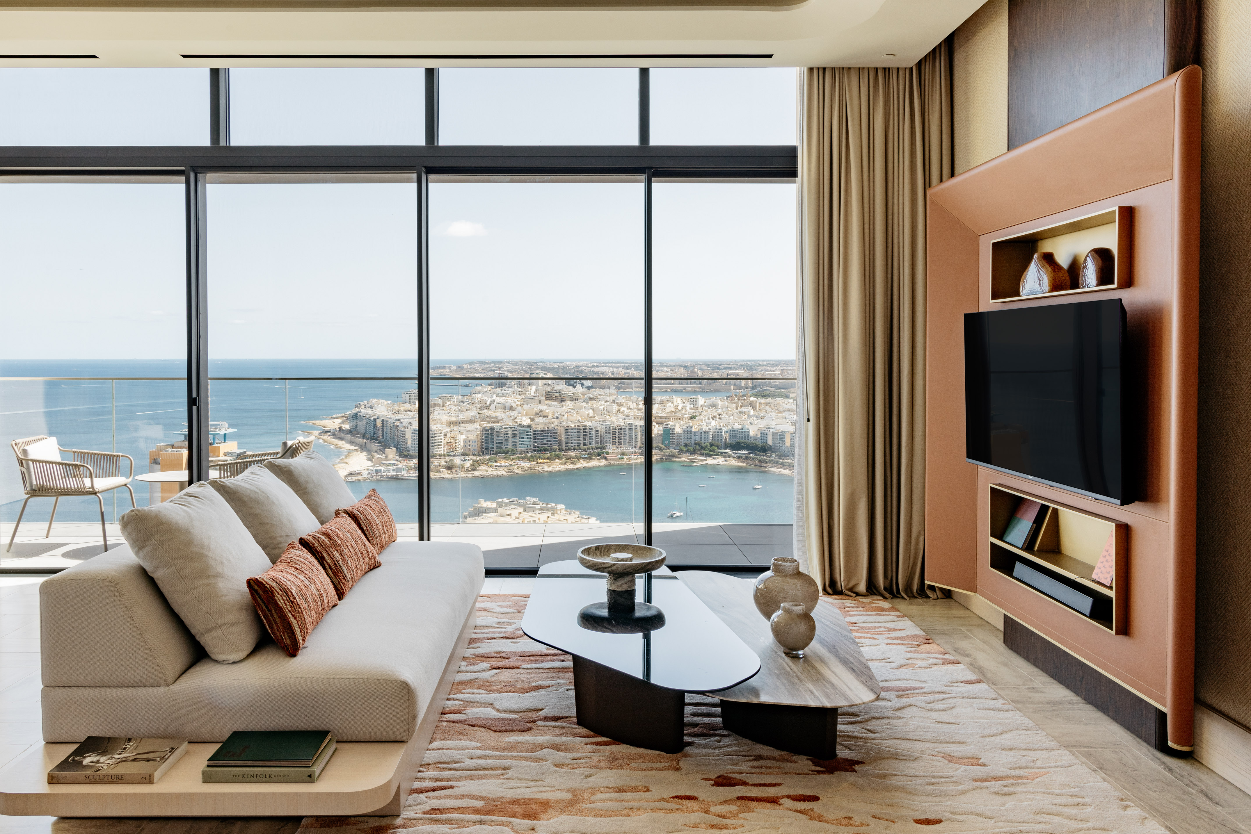 Contemporary living room with expansive ocean view, sofa, and stylish decor.