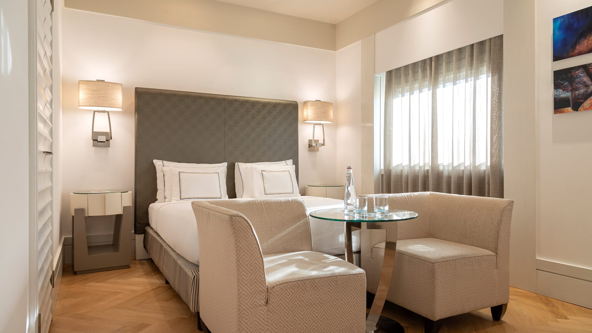 a room with a bed and chairs