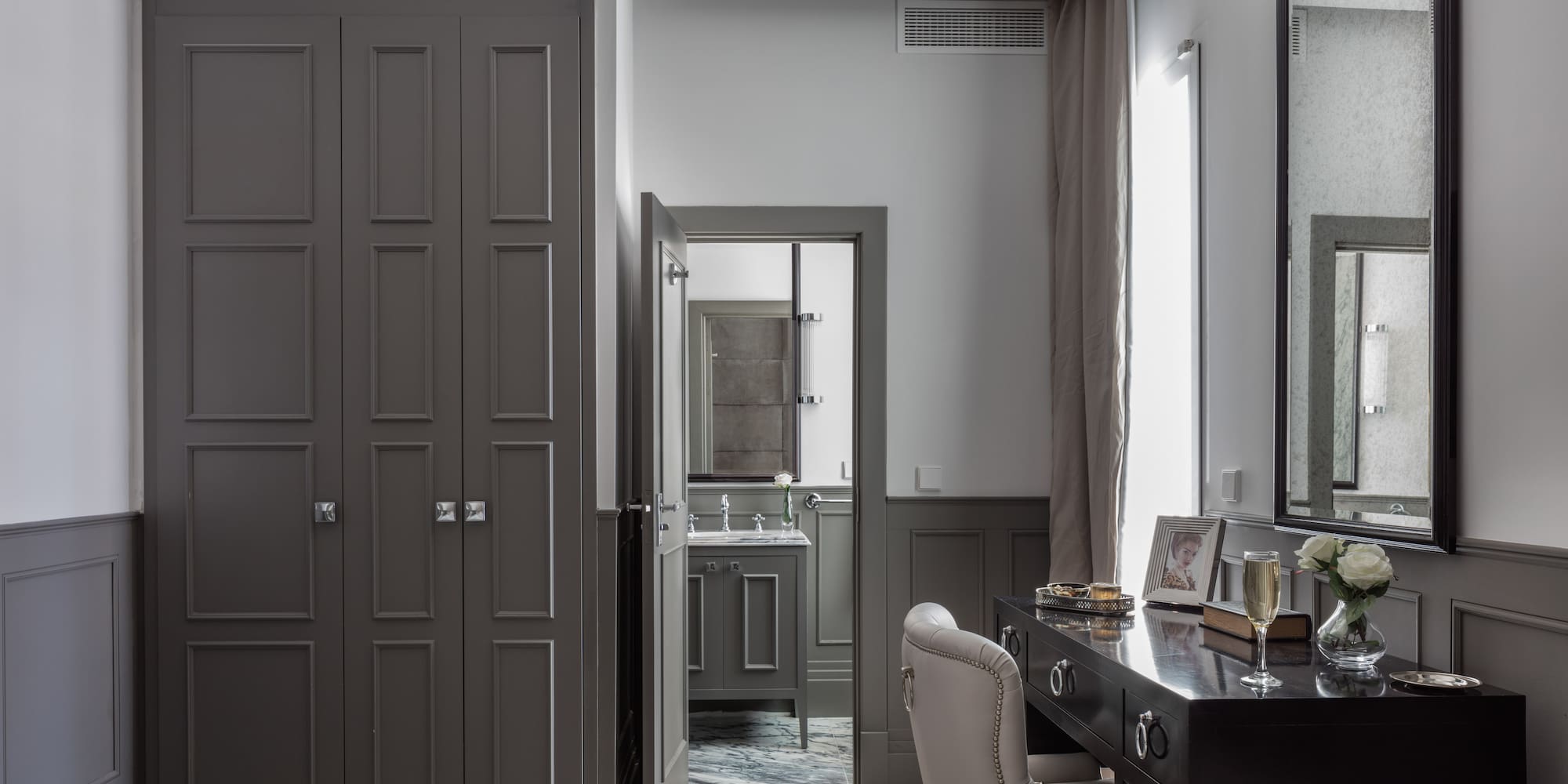 a room with a desk and a mirror