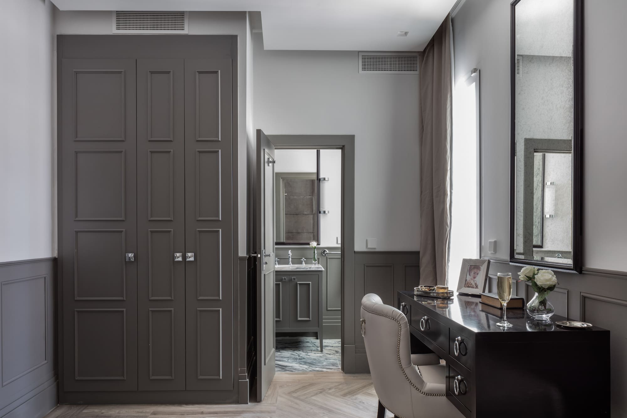 a room with a desk and a mirror