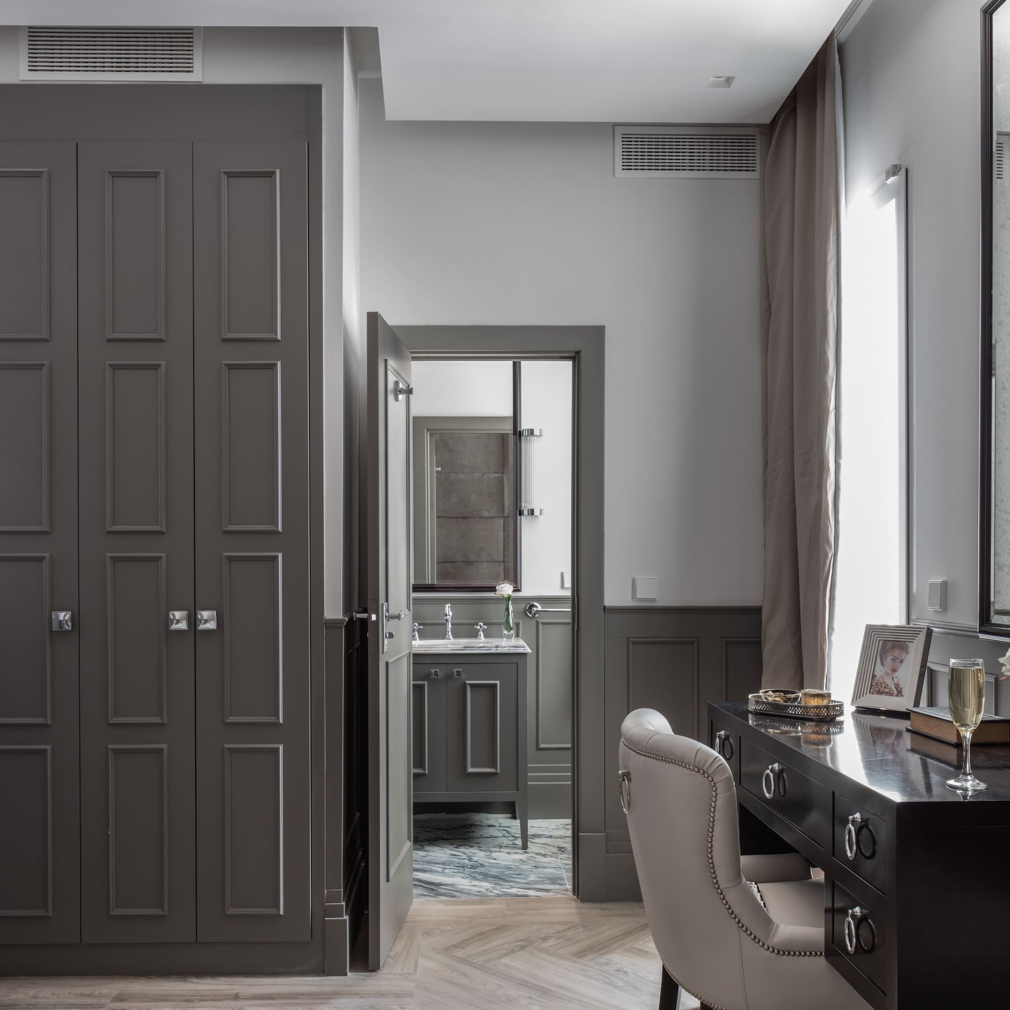 a room with a desk and a mirror