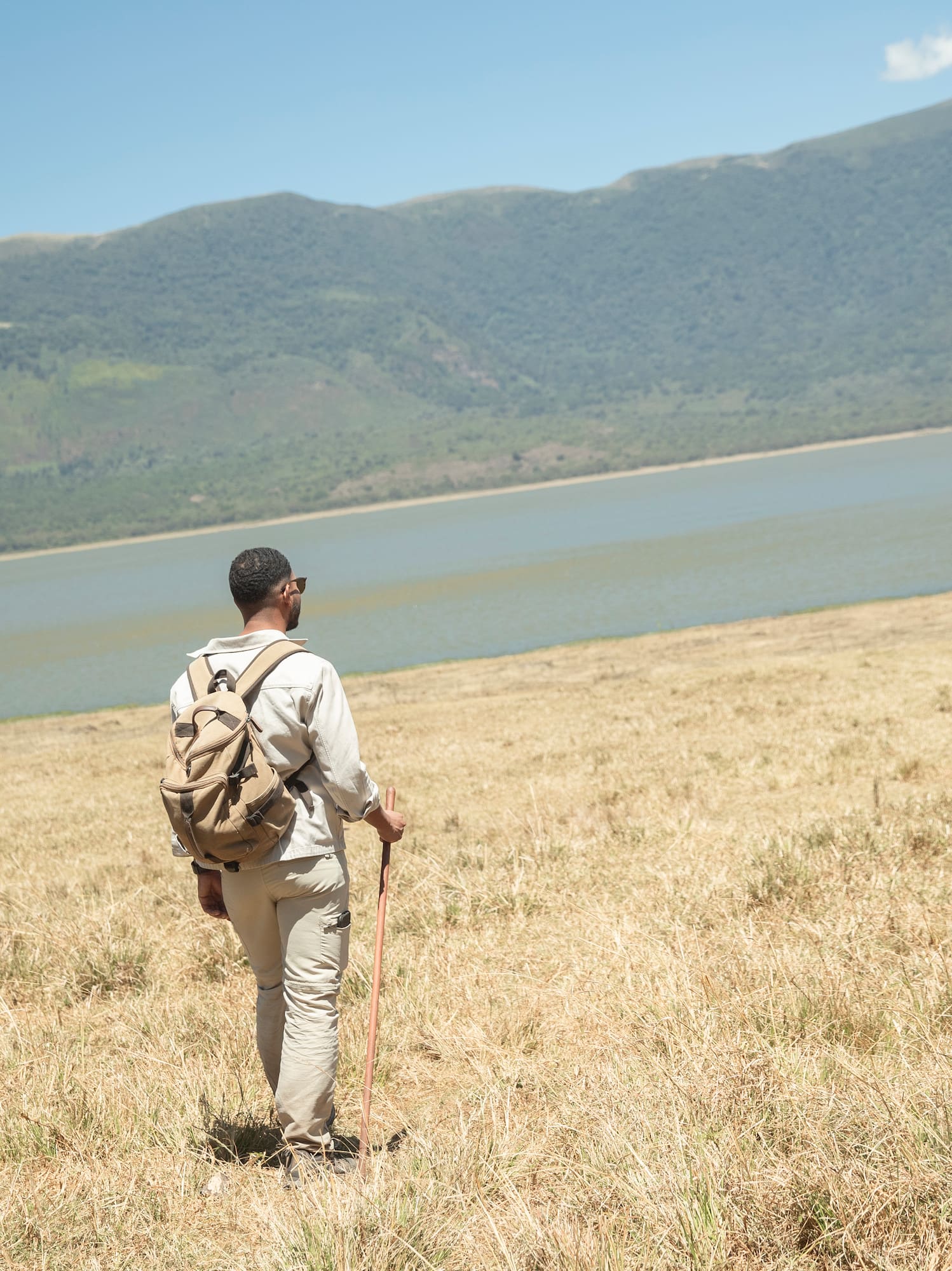 a couple of people hiking in a field