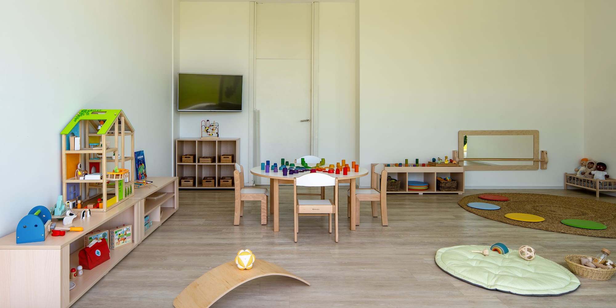 a room with a table and chairs and toys