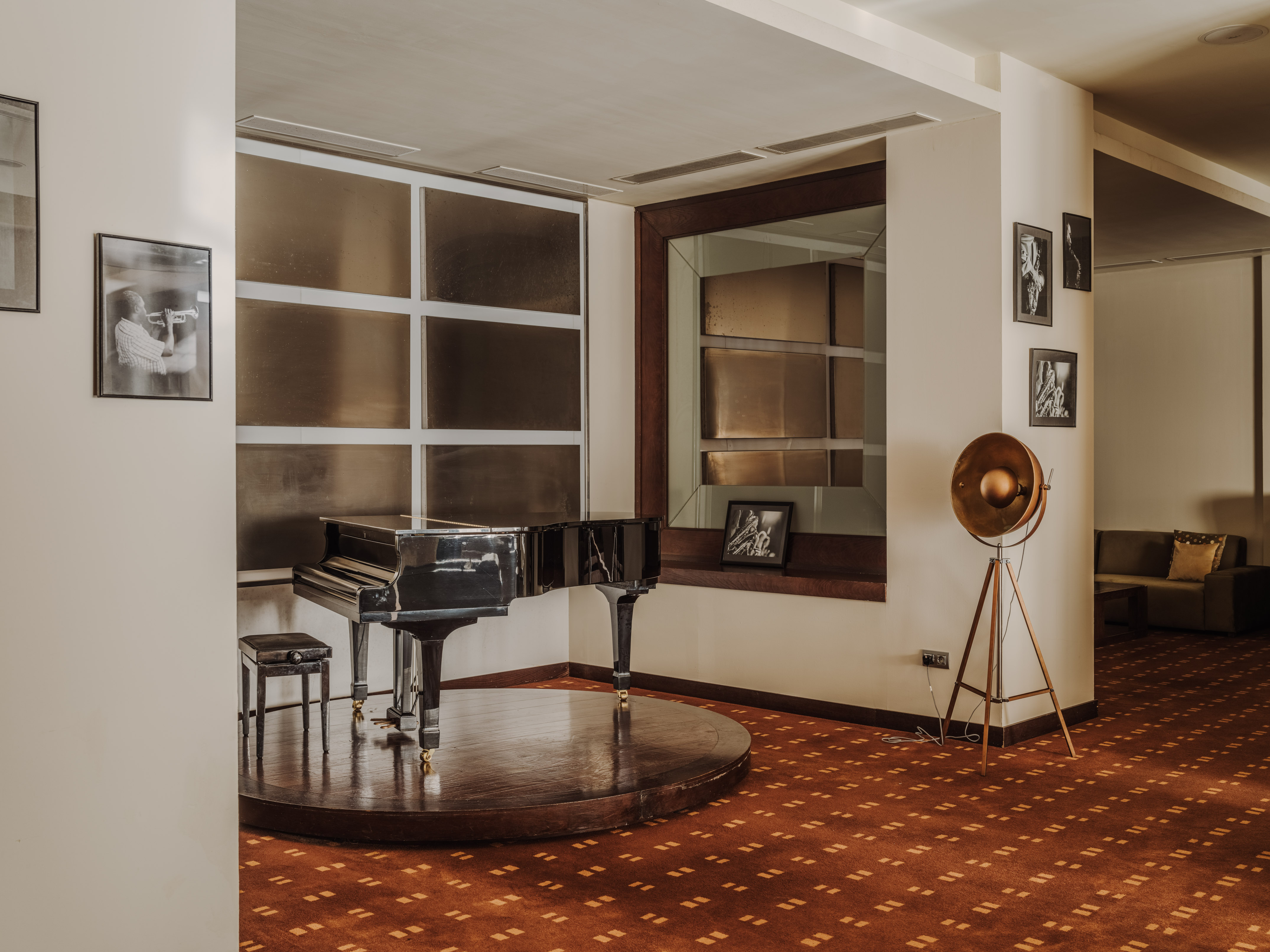 a piano on a round platform in a room