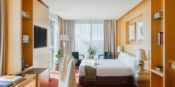 a room with a bed and a tv