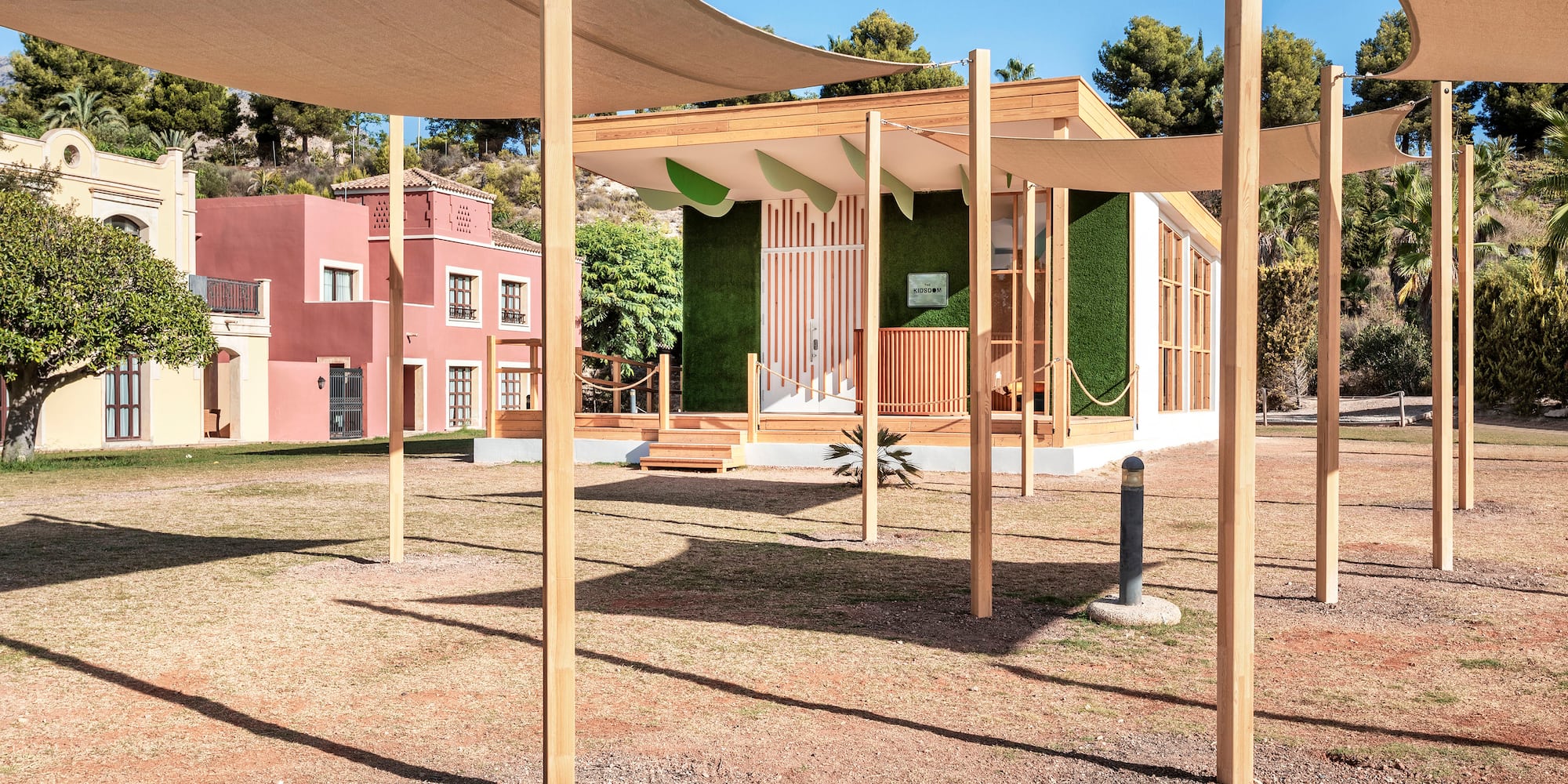 a building with a white roof and a green wall