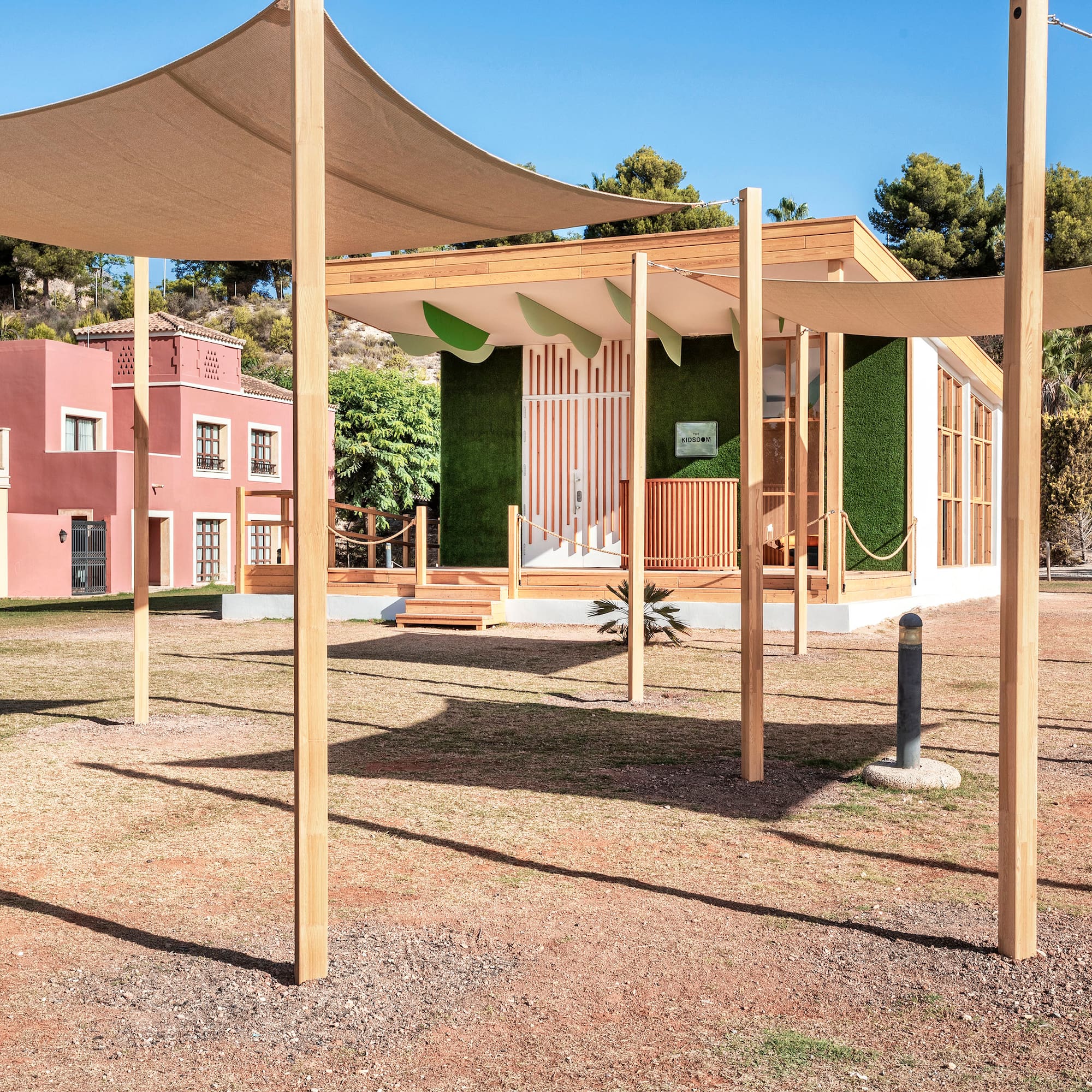 a building with a white roof and a green wall
