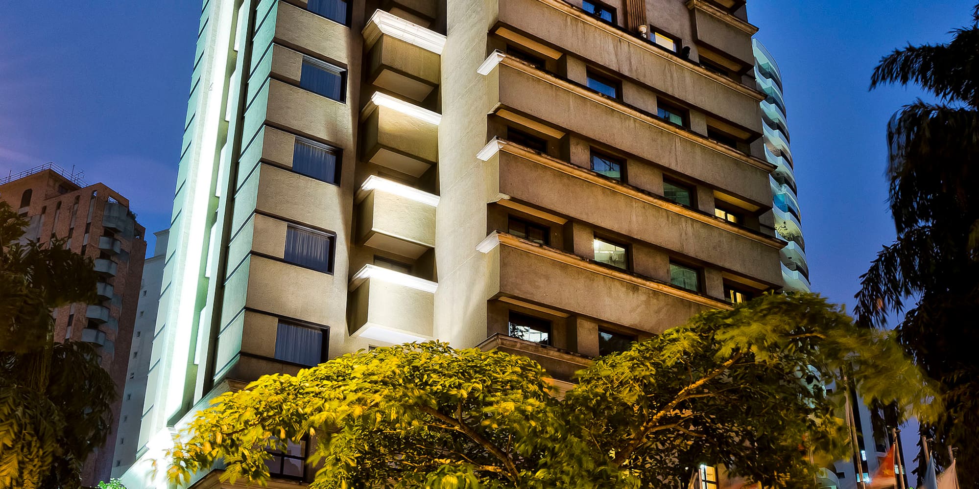a tall building with trees in front of it