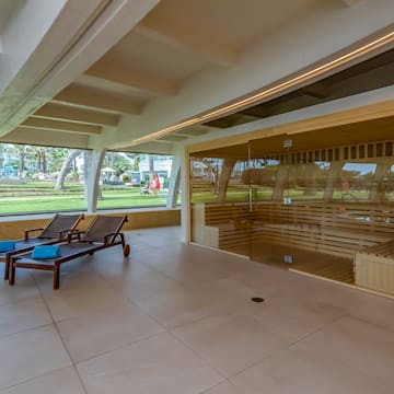 a room with a sauna and chairs