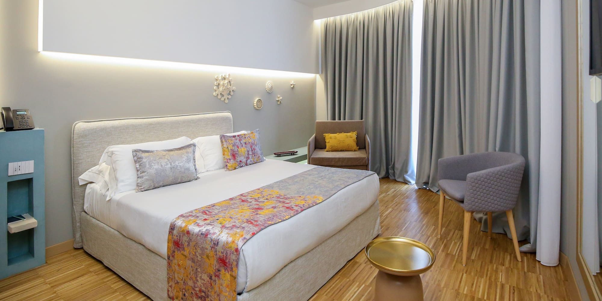 a room with a bed and chairs