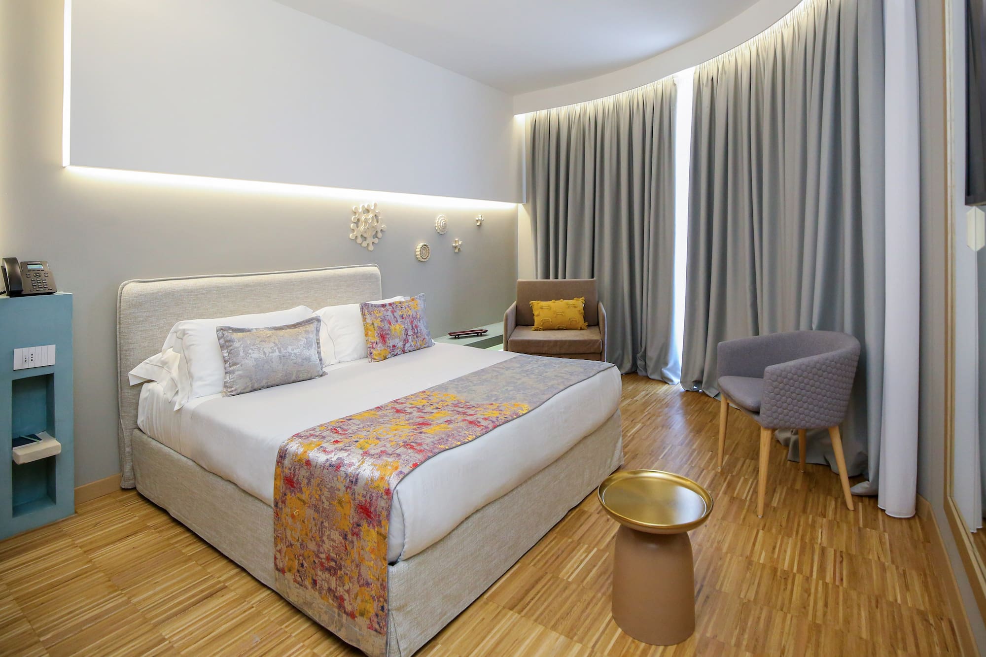 a room with a bed and chairs