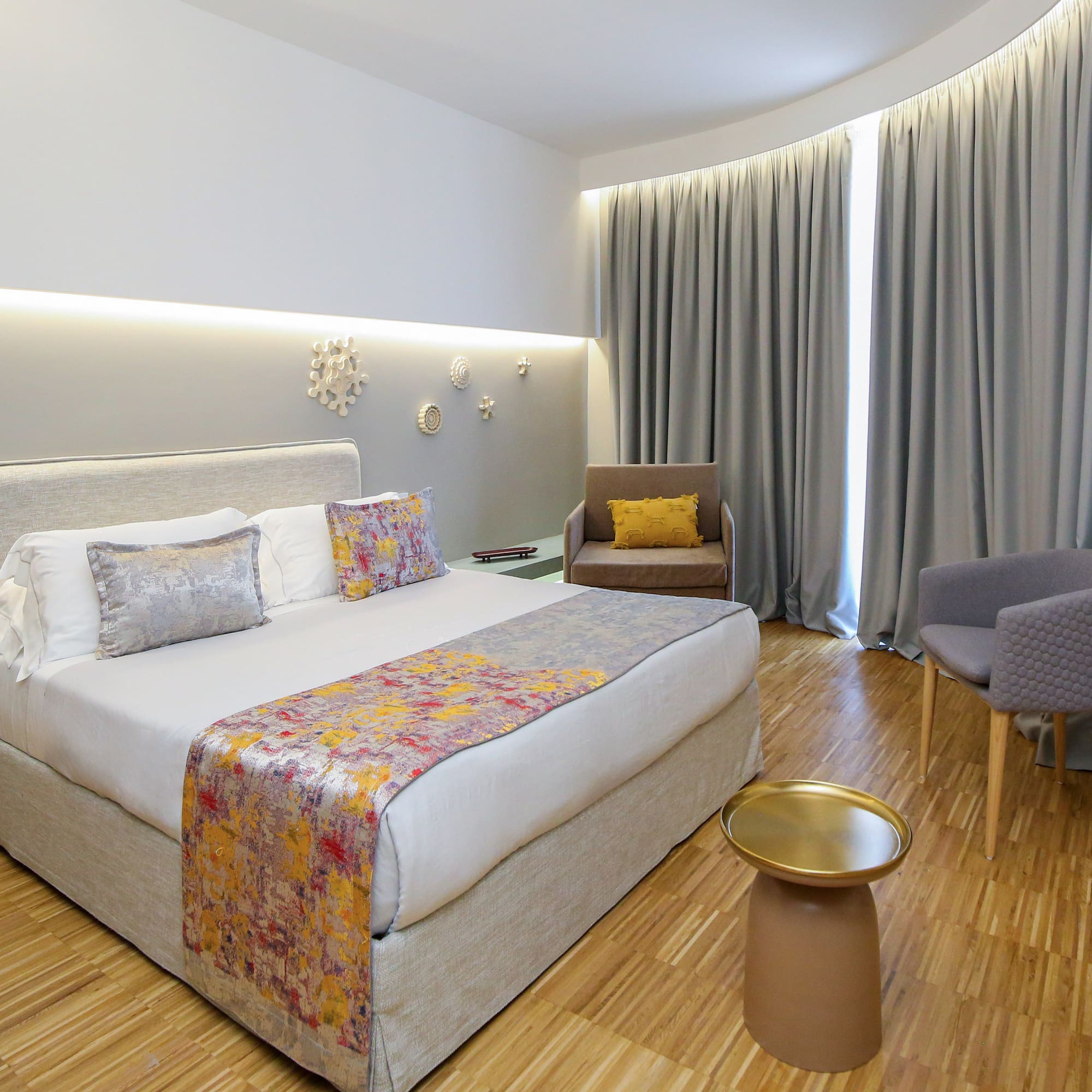 a room with a bed and chairs