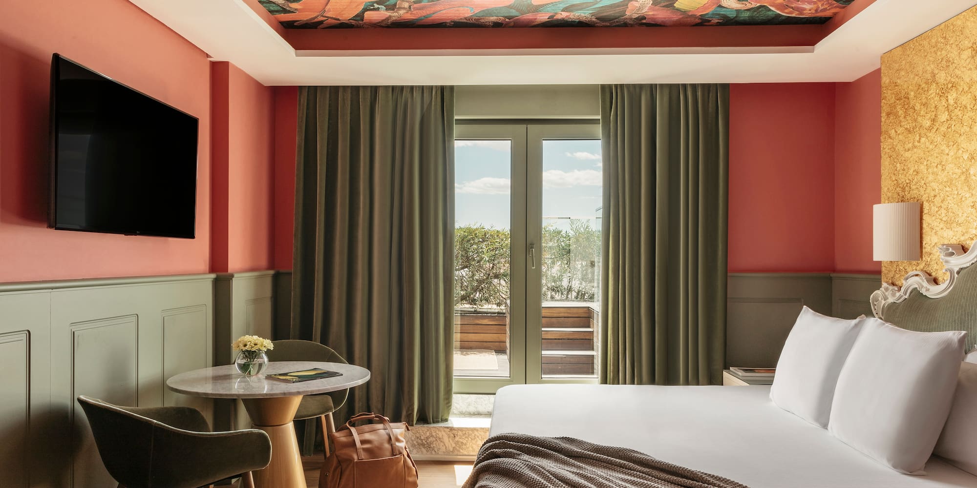 a room with a bed and a table and chairs