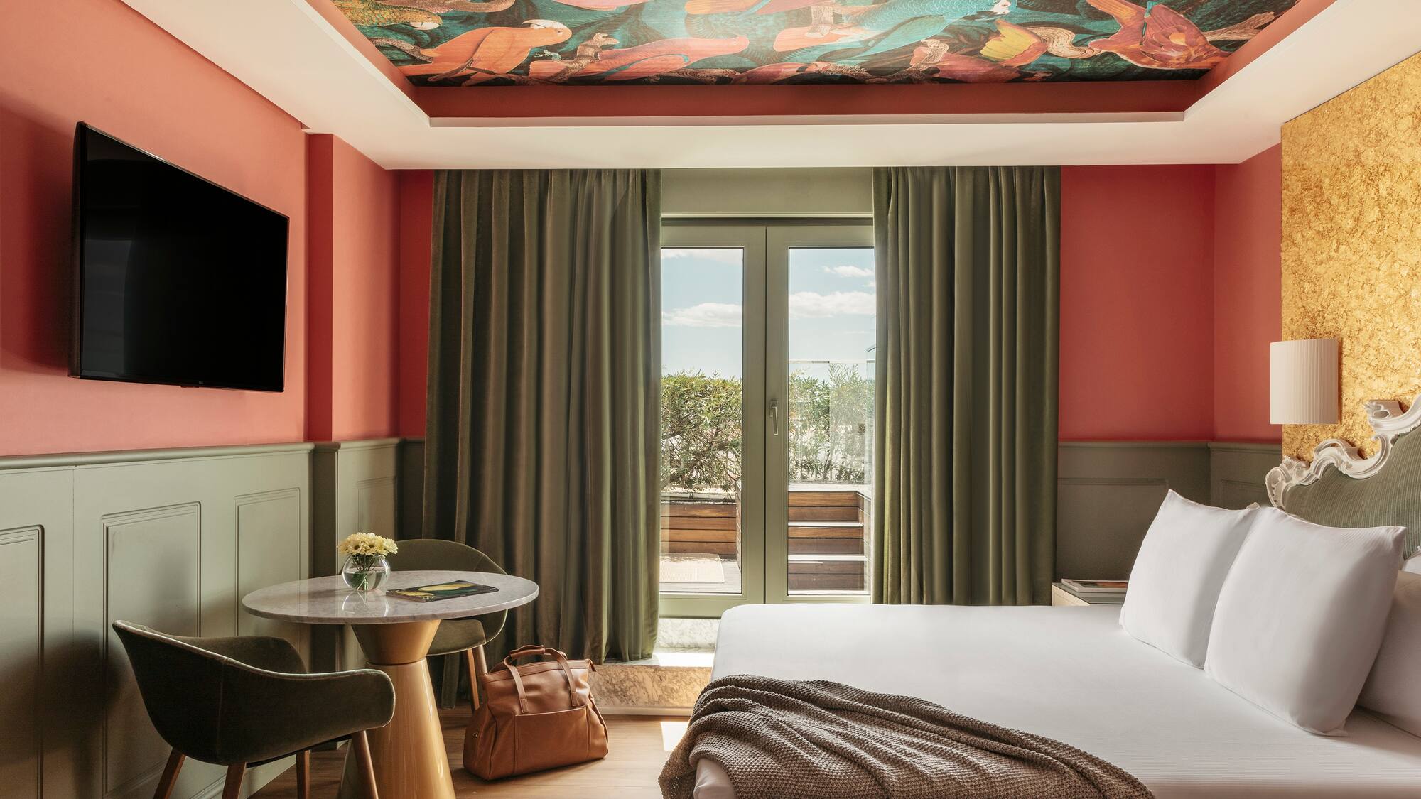 a room with a bed and a table and chairs