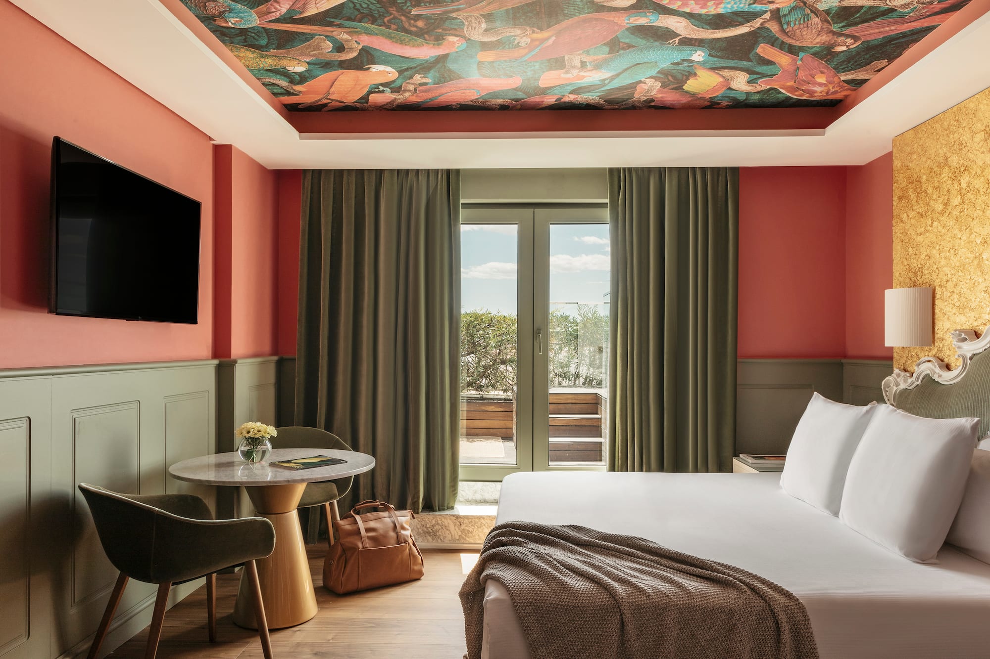 a room with a bed and a table and chairs