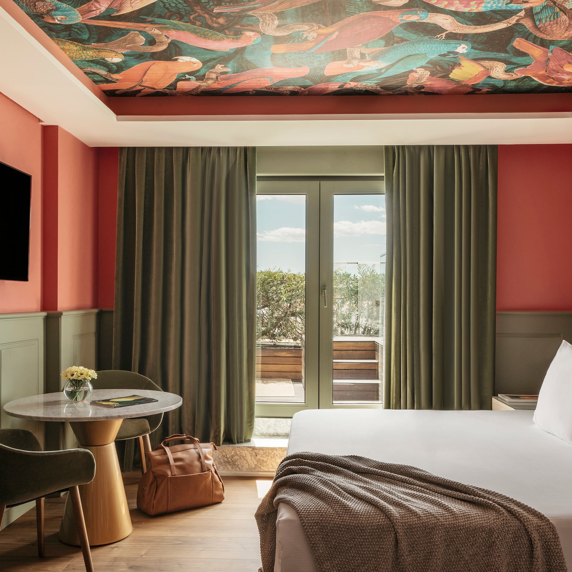 a room with a bed and a table and chairs