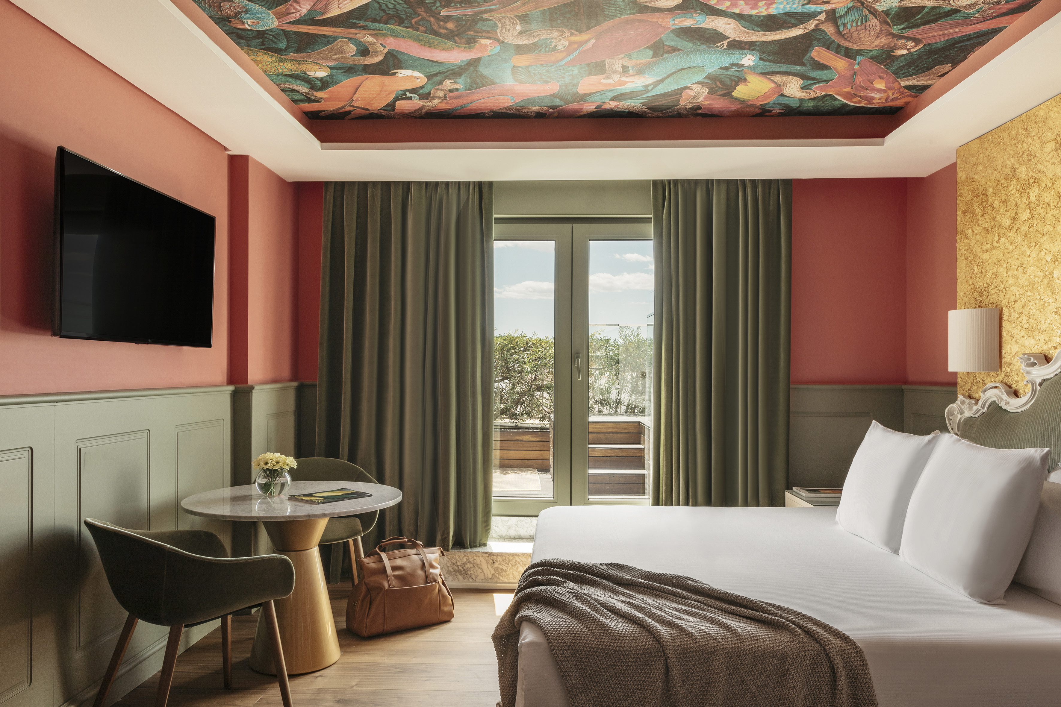 a room with a bed and a table and chairs